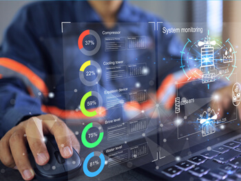 Stock image of a man working on a computer with system monitoring stats in the background